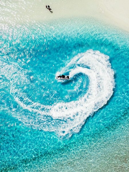 Arial view of a boat in blue water